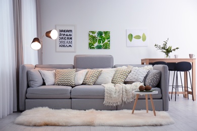 Photo of Beautiful room interior with comfortable sofa