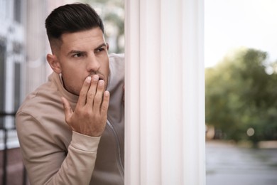 Image of Man spying on his girlfriend in park. Cheating concept