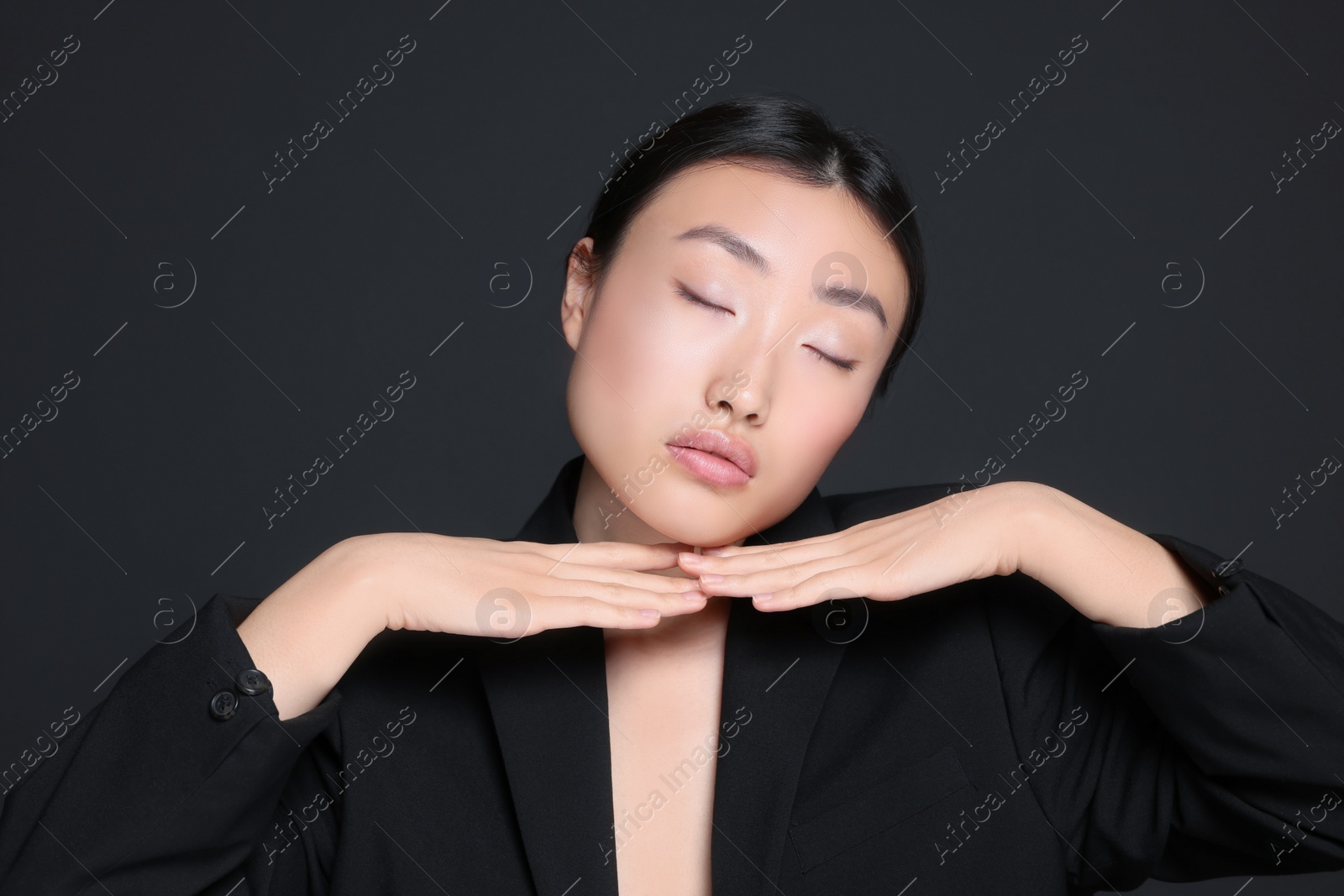 Photo of Portrait of beautiful young Asian woman on black background