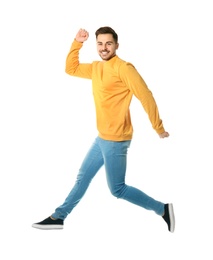Photo of Full length portrait of happy handsome man jumping on white background