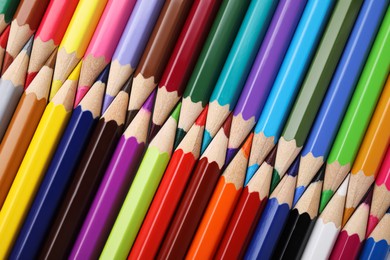 Many colorful wooden pencils as background, top view