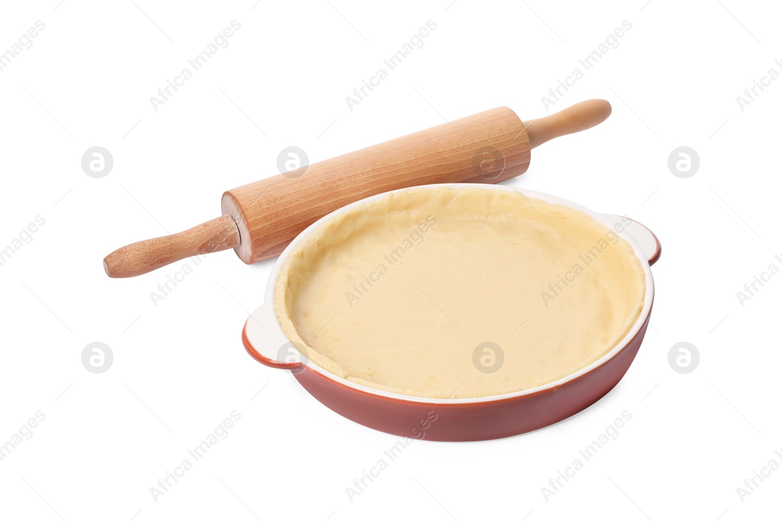 Photo of Pie tin with fresh dough and rolling pin isolated on white. Making quiche