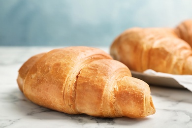 Photo of Tasty croissant on table, closeup