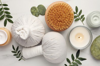 Flat lay composition with different spa products on white marble table