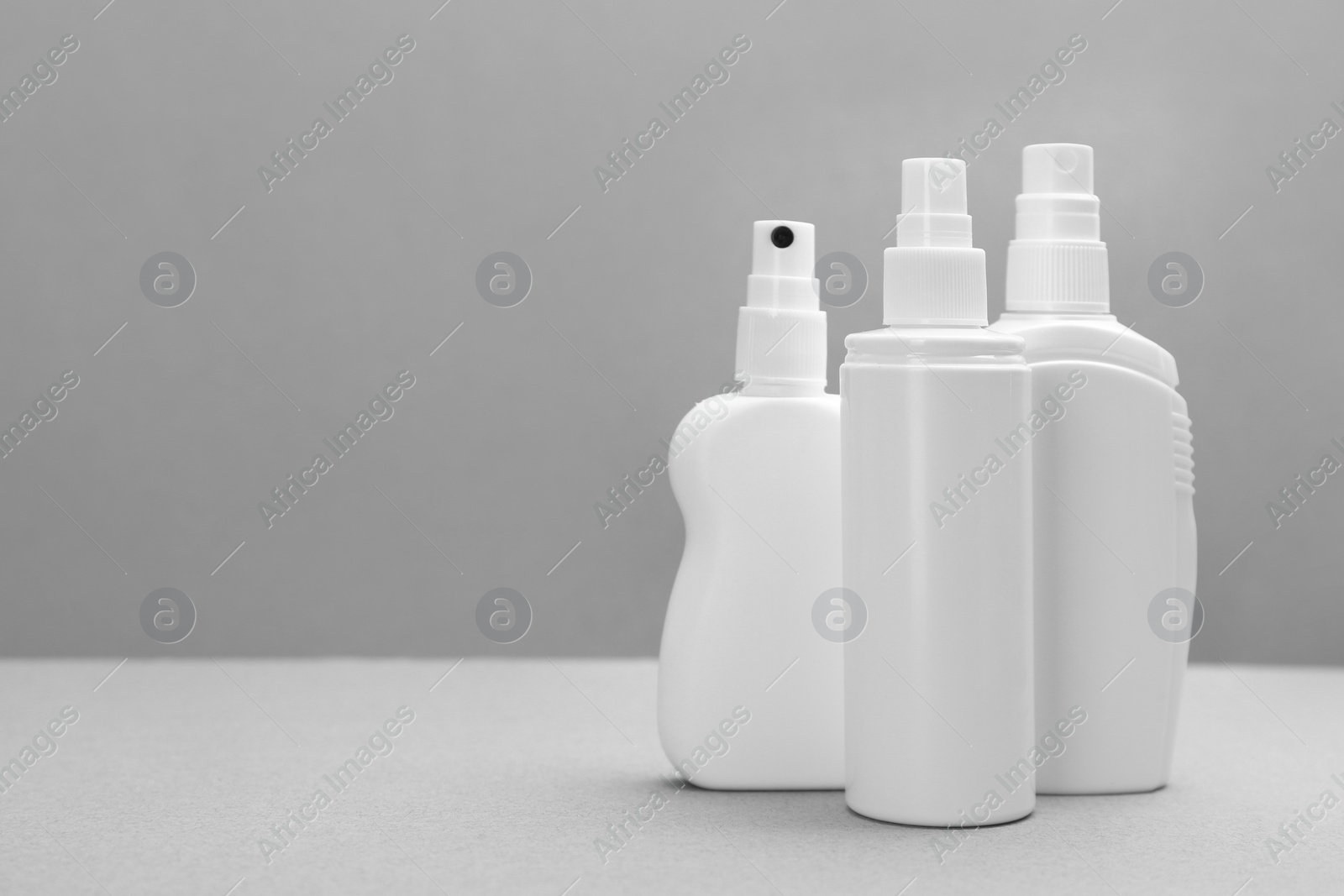 Photo of Set of different insect repellents on grey background. Space for text