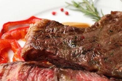 Photo of Delicious grilled beef steak with spices, closeup