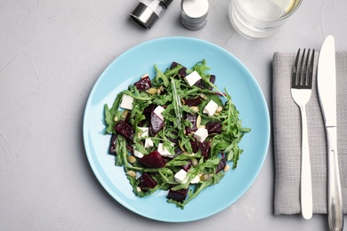 Fresh delicious beet salad on grey table, flat lay