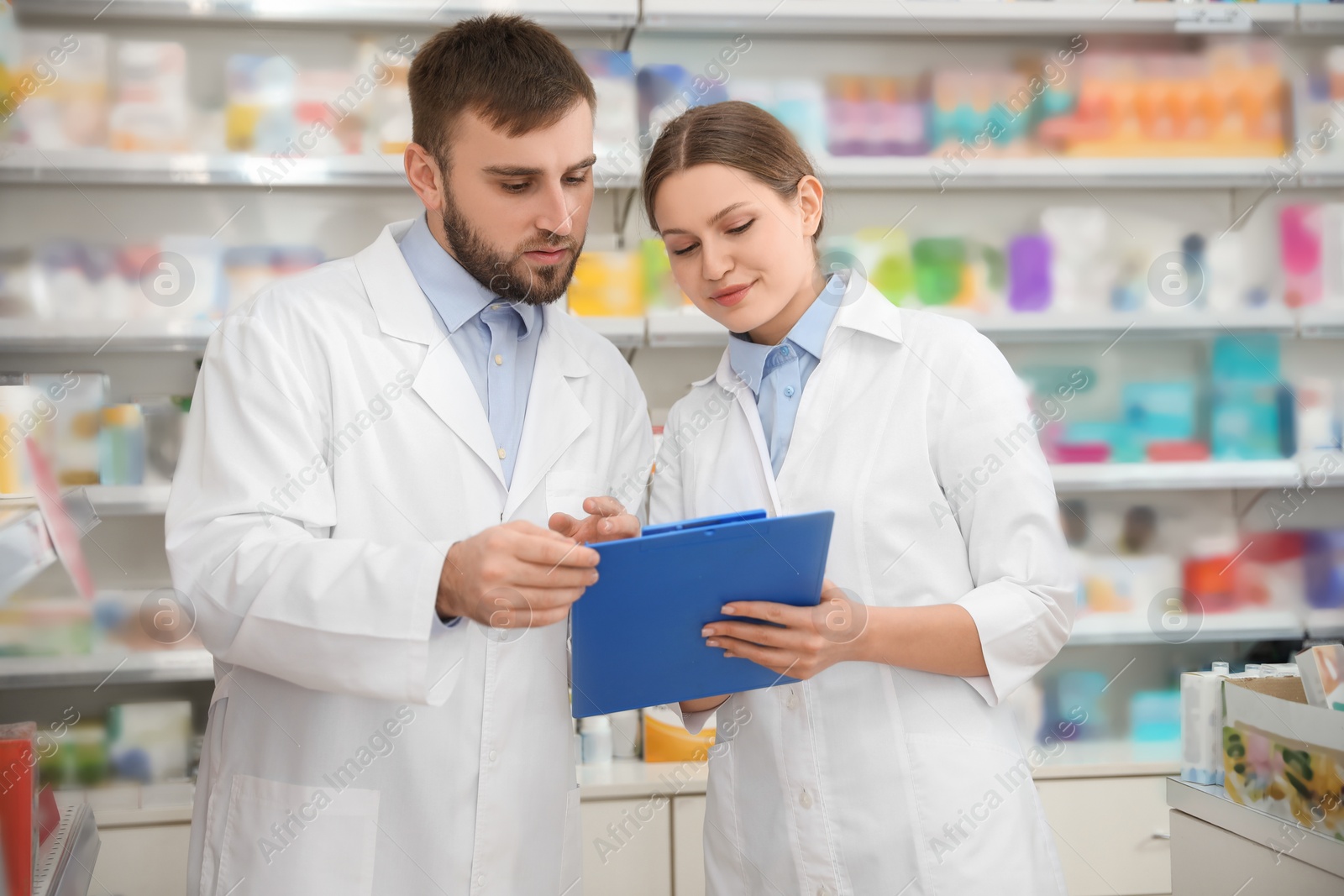 Photo of Professional pharmacists working together in modern drugstore