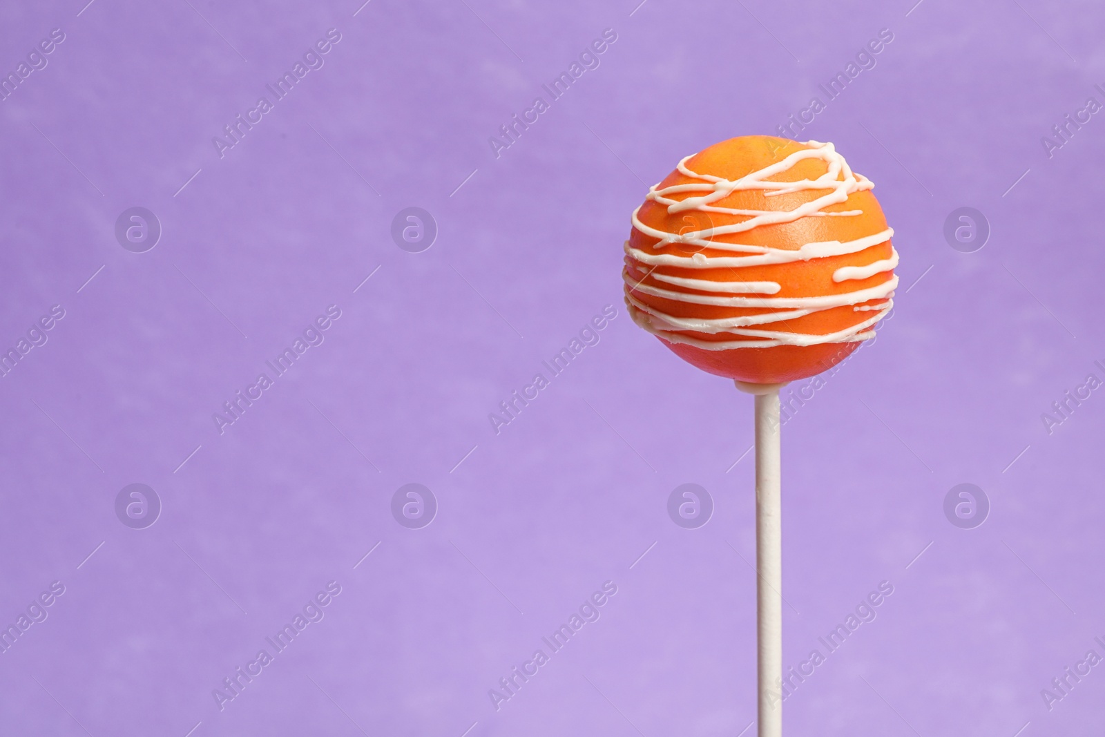 Photo of Bright delicious cake pop on color background. Space for text