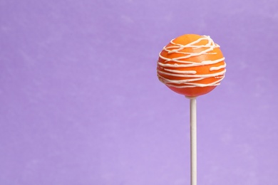 Bright delicious cake pop on color background. Space for text