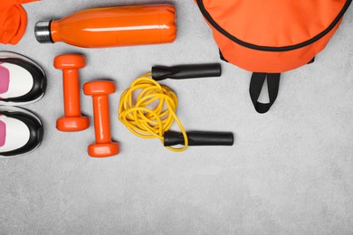 Photo of Different sports equipment on light grey table, flat lay. Space for text