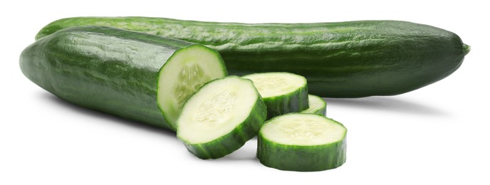 Photo of Whole and cut long cucumbers isolated on white