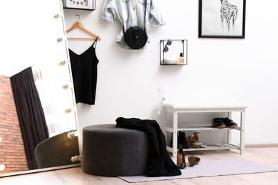 Large mirror with light bulbs in stylish room interior