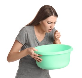 Photo of Woman with basin suffering from nausea on white background. Food poisoning