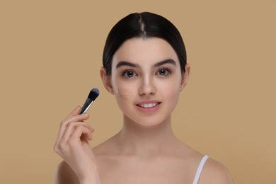 Photo of Teenage girl applying foundation on face with brush against beige background