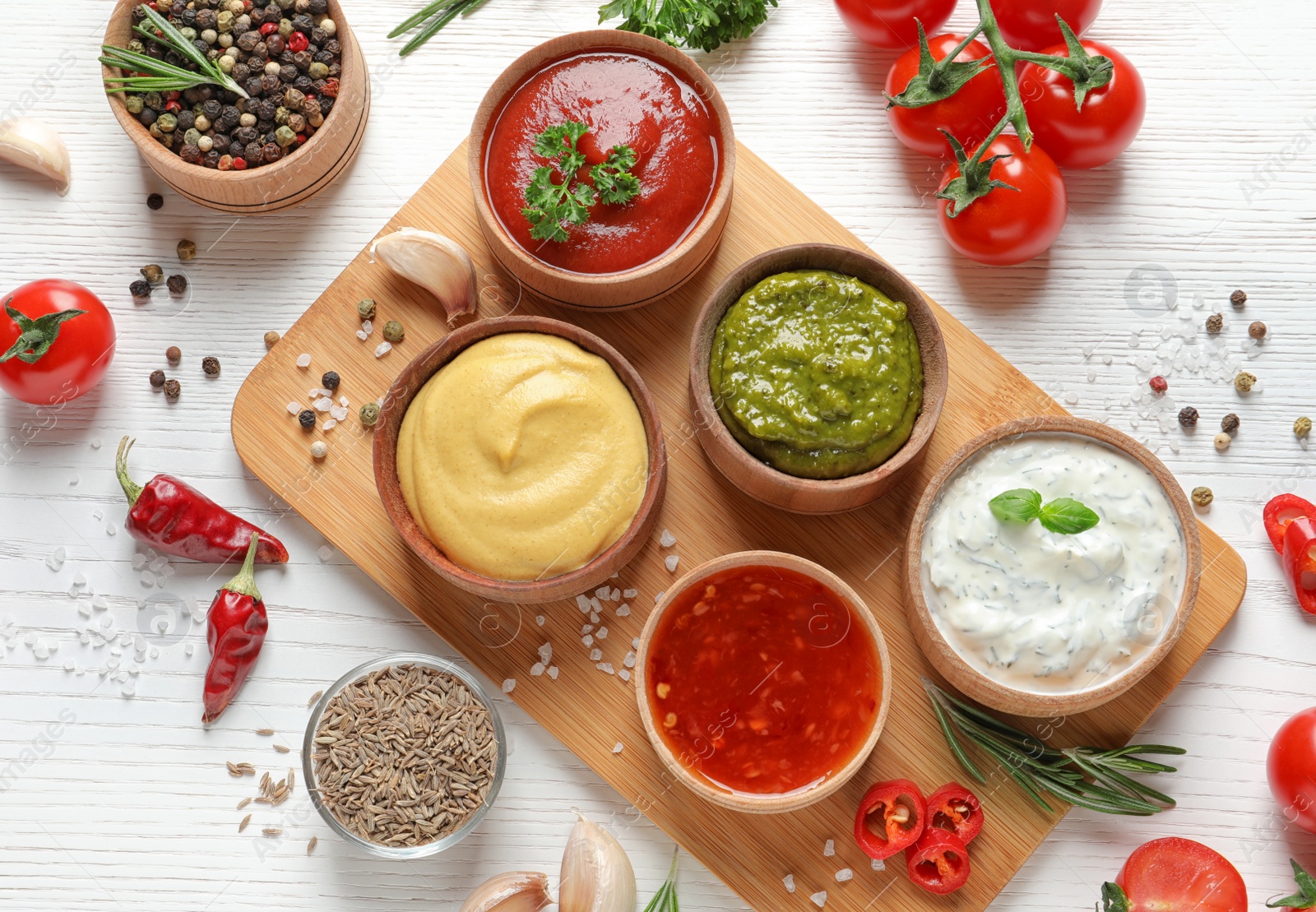 Photo of Flat lay composition with different sauces and ingredients on white wooden background