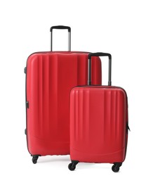 Photo of Red suitcases for travelling on white background