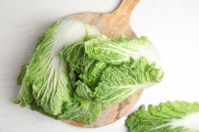 Photo of Fresh ripe Chinese cabbages on white wooden table, top view