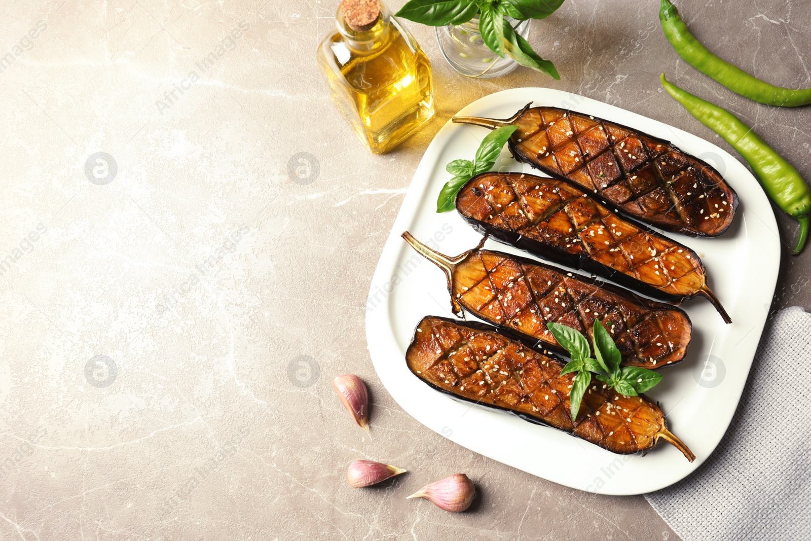 Photo of Plate with fried eggplant slices on table, top view. Space for text