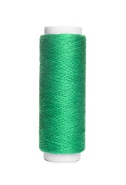 Photo of Spool of green sewing thread isolated on white