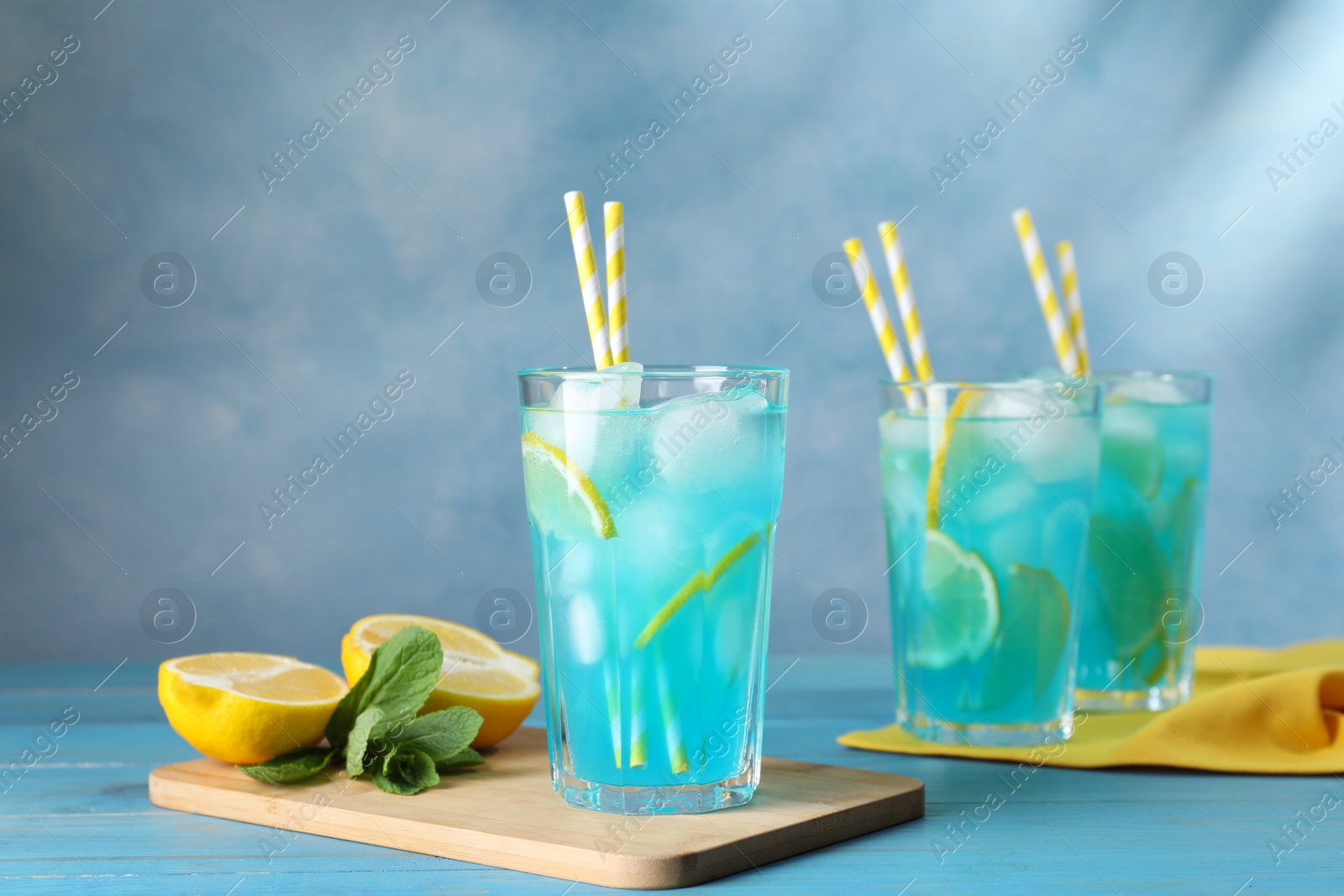 Photo of Delicious refreshing cocktail with ice on wooden table