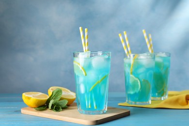Photo of Delicious refreshing cocktail with ice on wooden table