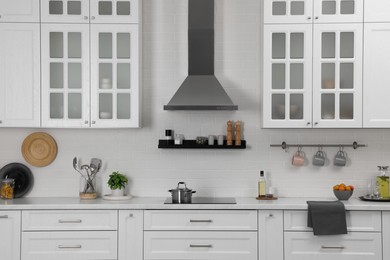 Photo of Elegant kitchen interior with range hood and furniture