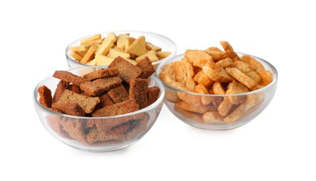 Photo of Different crispy rusks in bowls on white background