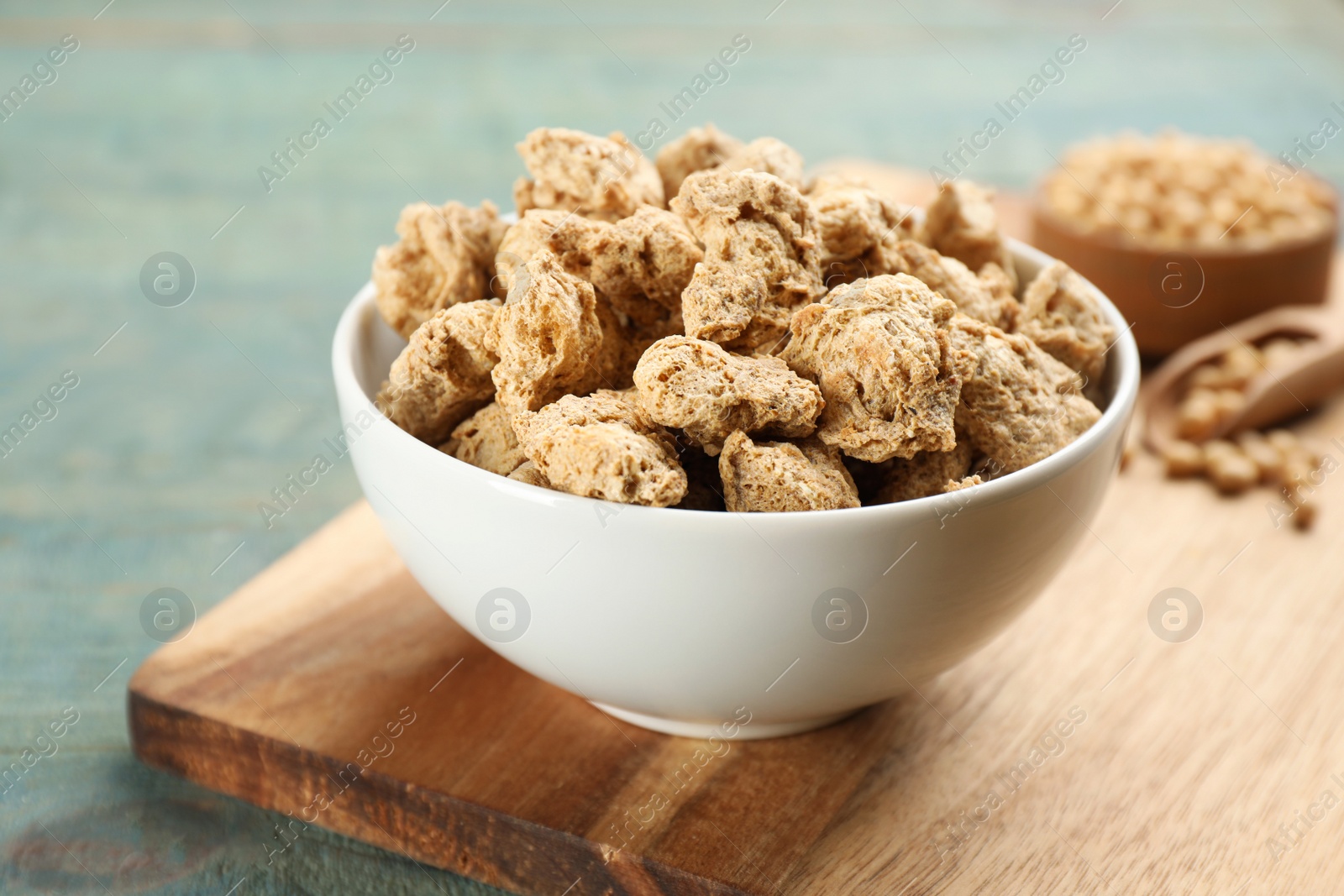 Photo of Dried soy meat on light blue wooden table, closeup