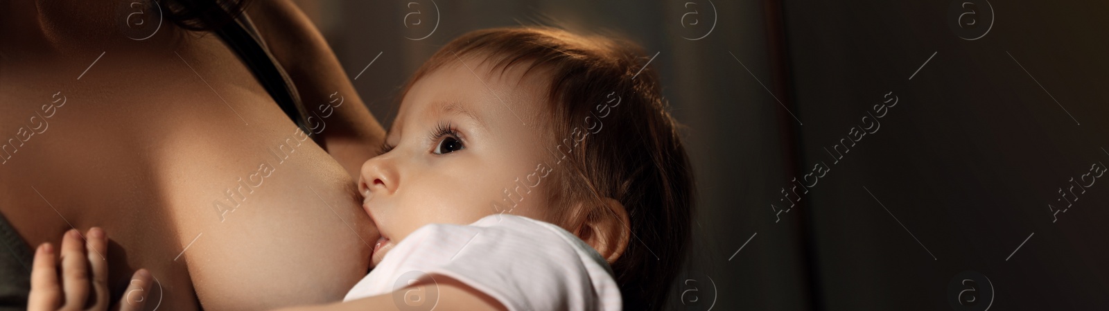 Image of Woman breast feeding her little baby at home, closeup. Banner design