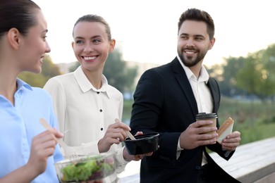 Photo of Business people spending time together during lunch outdoors