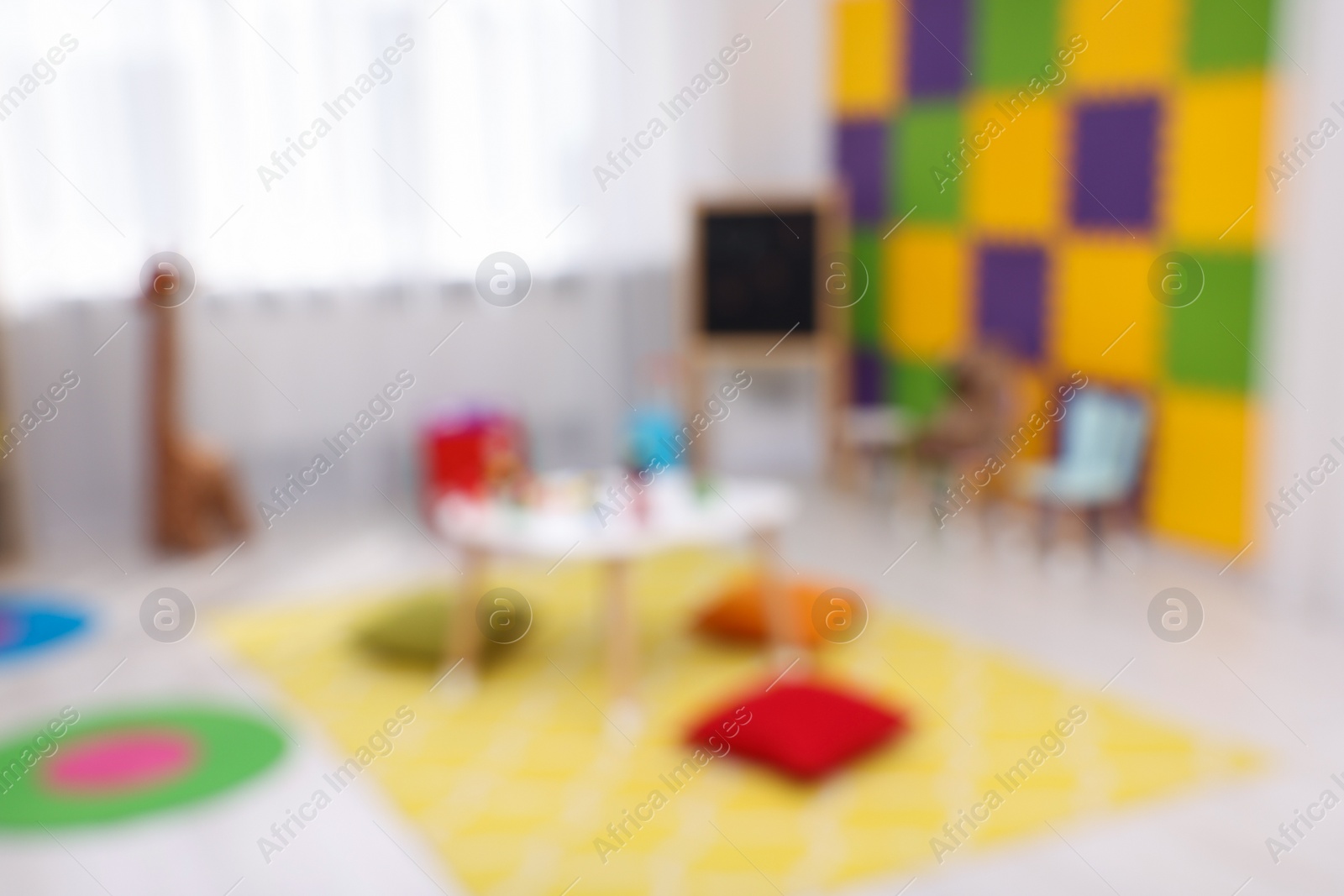 Photo of Blurred view of child`s playroom. Kindergarten interior