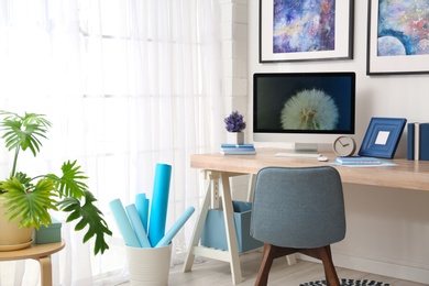 Photo of Modern workplace interior with computer on table