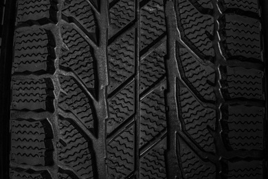 Photo of Winter tire as background, closeup. Car maintenance