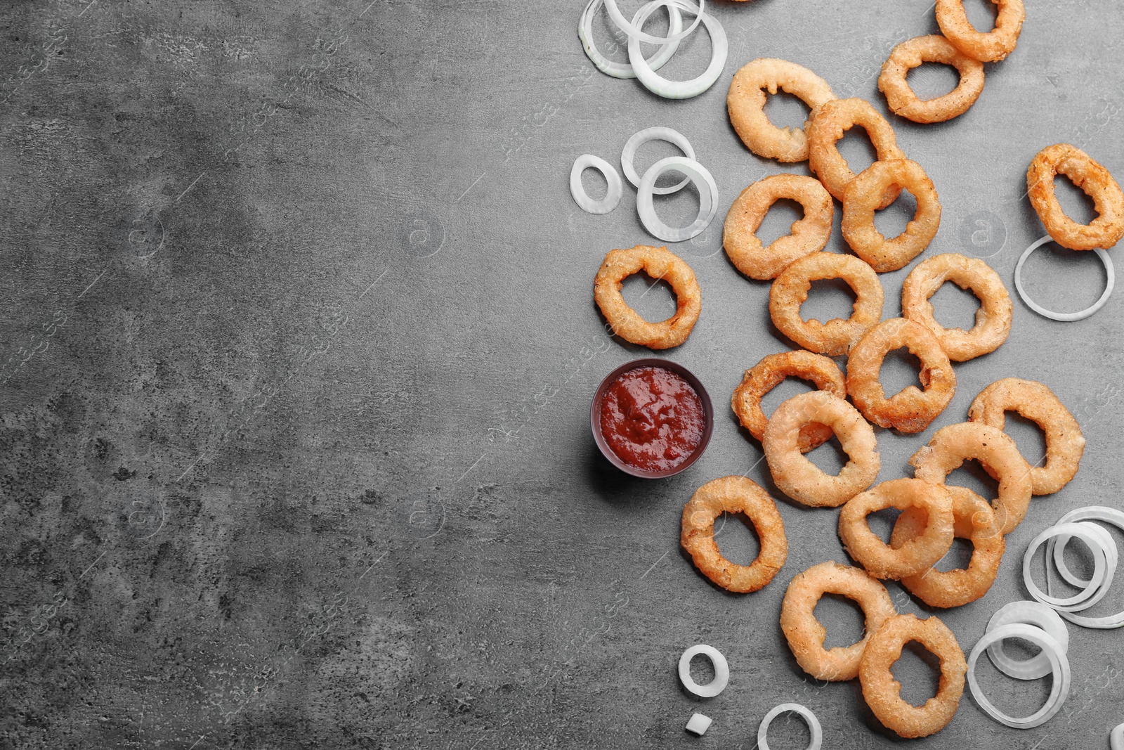 Photo of Flat lay composition with onion rings on grey background