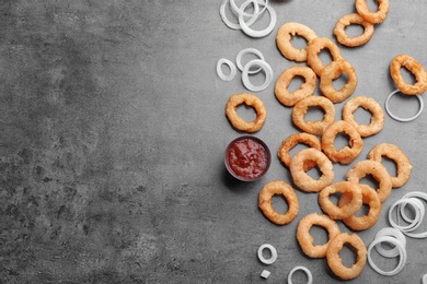 Flat lay composition with onion rings on grey background