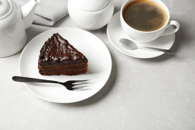 Tasty chocolate cake served on grey table