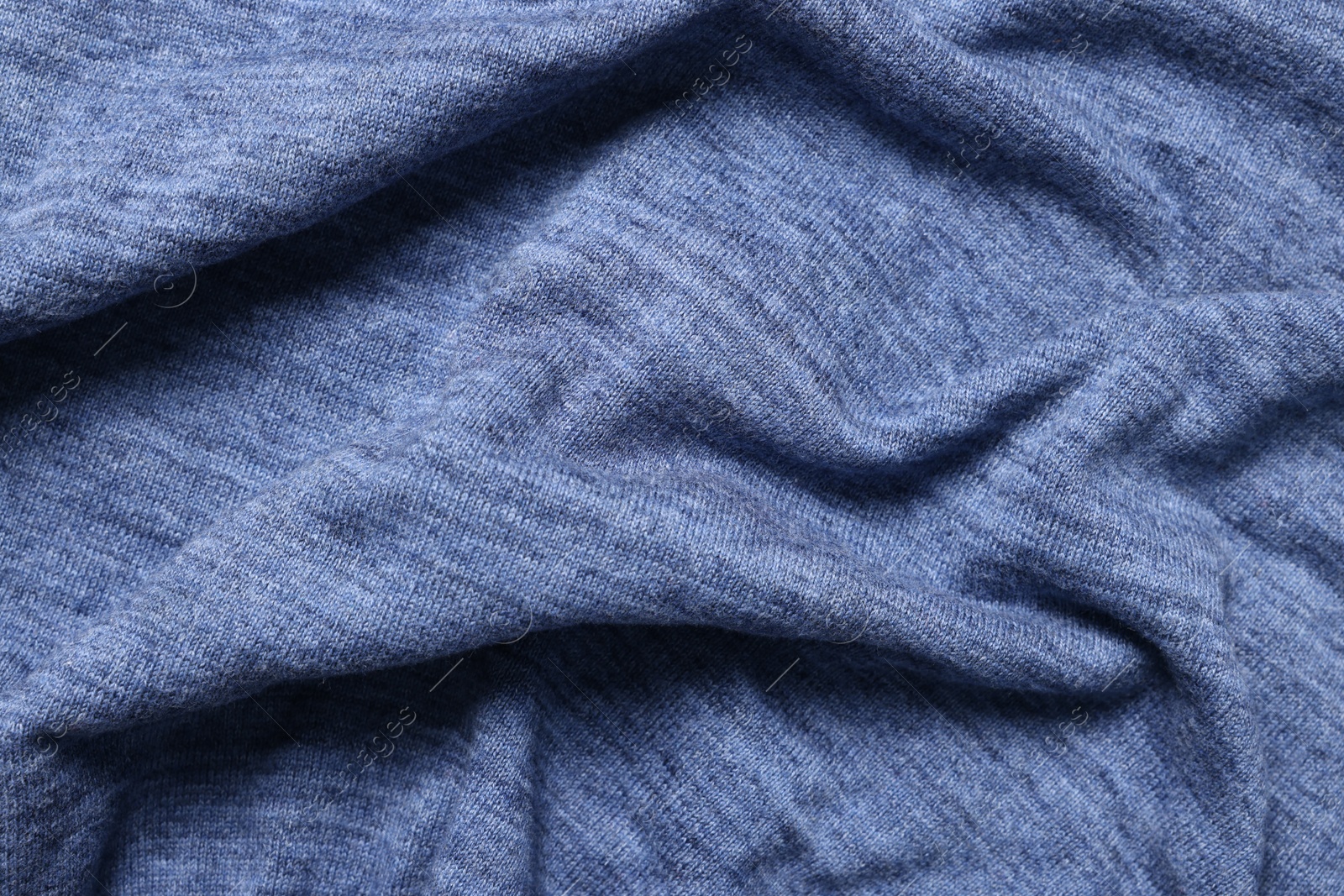 Photo of Texture of blue crumpled fabric as background, top view