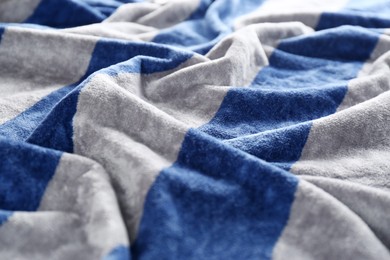 Photo of Crumpled striped beach towel as background, closeup view