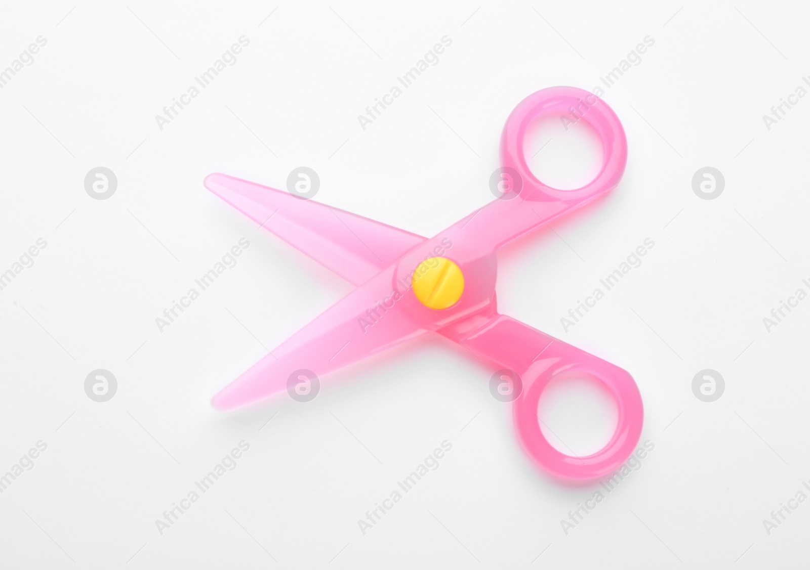 Photo of Colorful plastic scissors on white background. School stationery