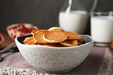 Photo of Delicious mini pancakes cereal served on table