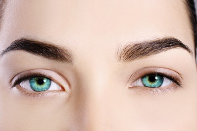 Image of Beautiful woman with captivating turquoise eyes, closeup
