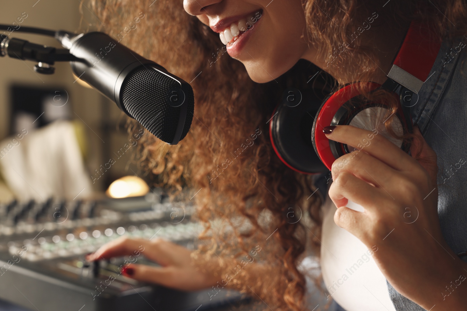 Photo of African American woman working as radio host in modern studio, closeup