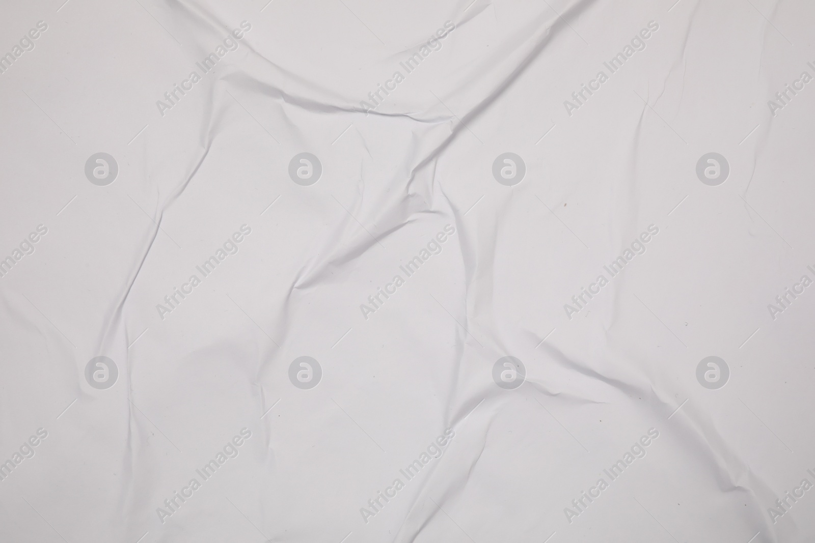 Photo of Top view of white creased blank poster as background, closeup