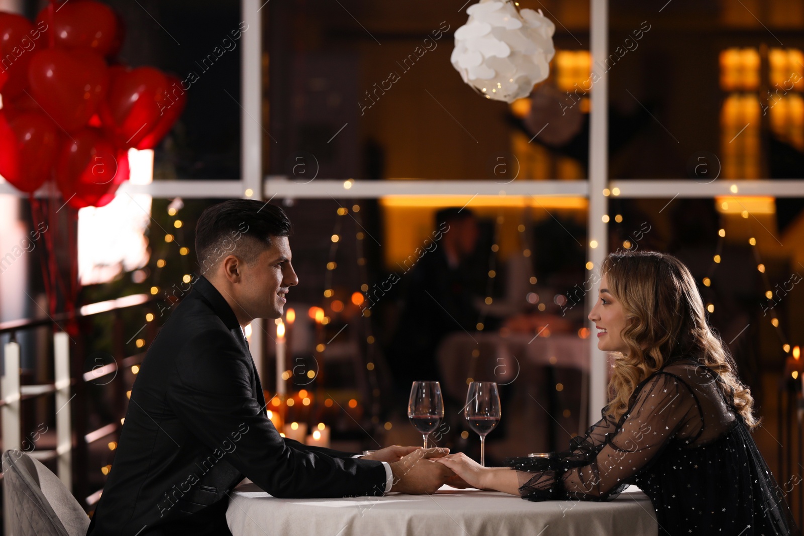 Photo of Lovely couple having romantic dinner on Valentine's day in restaurant