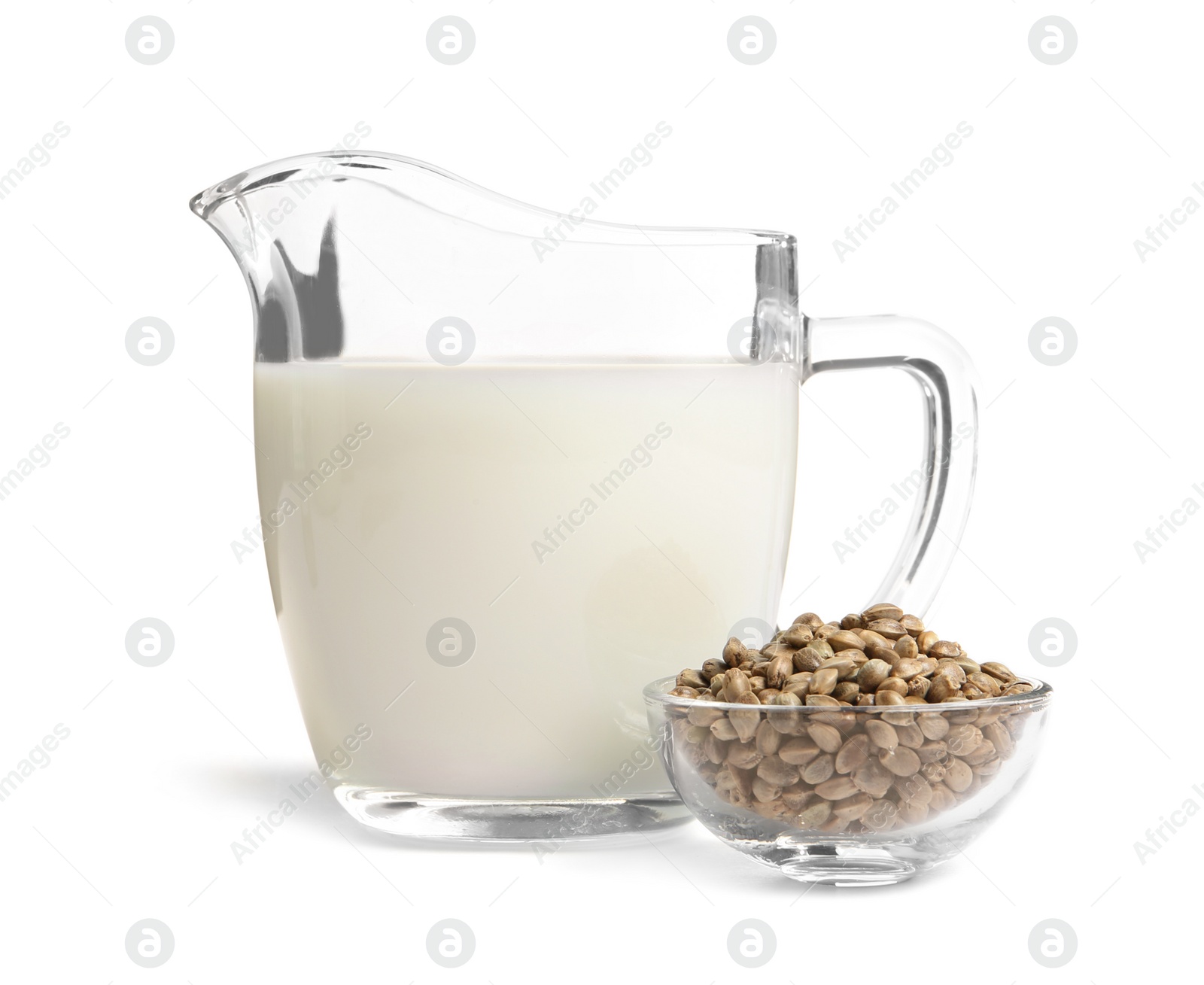 Photo of Bowl with hemp seeds and jug of milk on white background