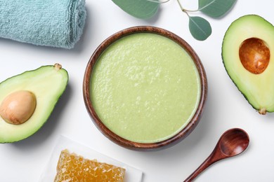 Homemade hair mask, towel and ingredients on white background, flat lay