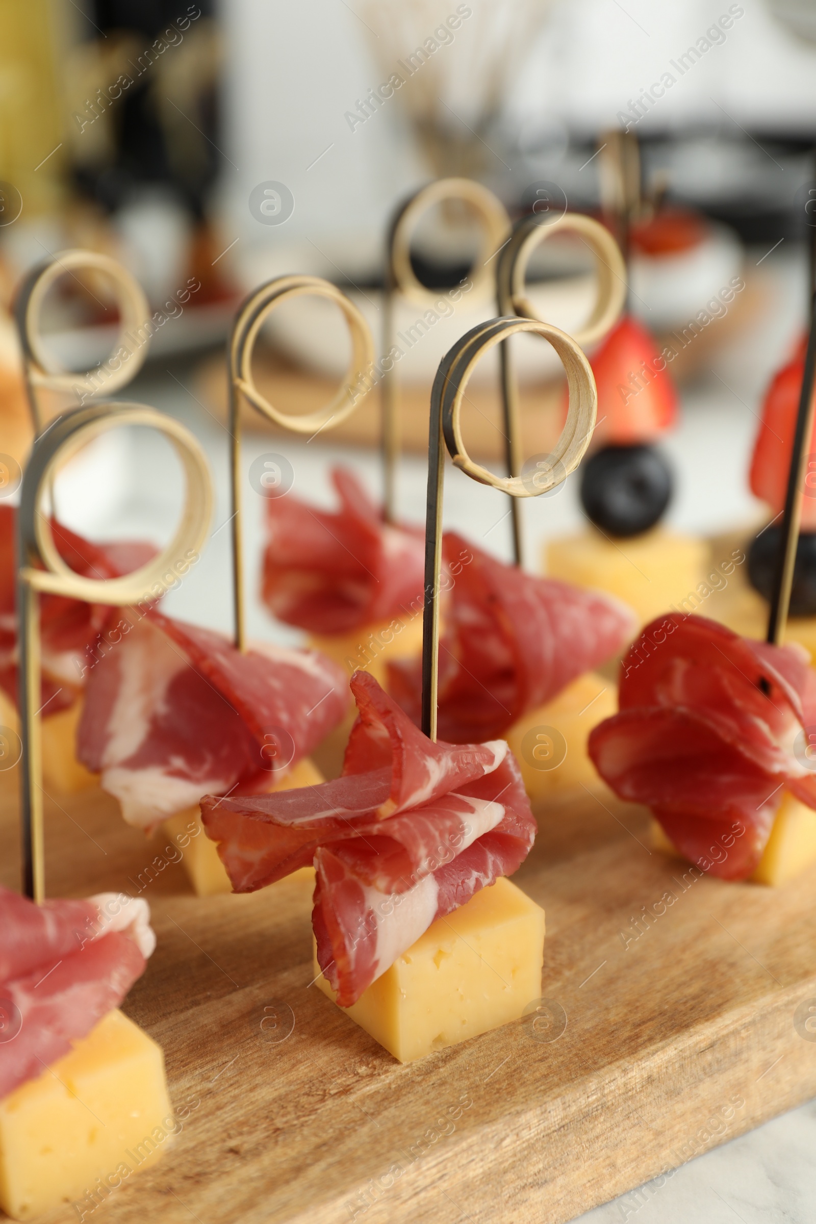 Photo of Different tasty canapes on white marble table, closeup