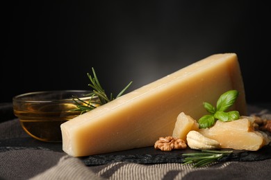 Photo of Delicious parmesan cheese, honey, walnuts and basil on grey tablecloth