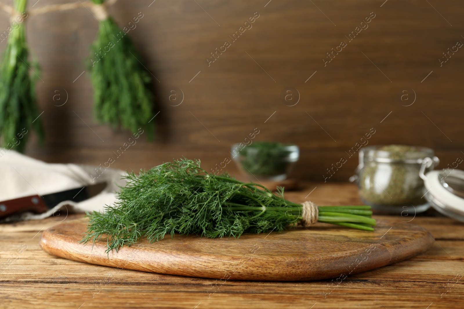 Photo of Fresh dill preparing for drying on wooden board. Space for text